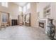 Stylish living room with tall windows, a fireplace, built-in shelves, and tile flooring at 872 Timber Walk Dr, Henderson, NV 89052