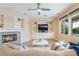 Inviting living room showcasing a fireplace, built-ins, and bright windows overlooking the pool at 872 Timber Walk Dr, Henderson, NV 89052