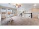 Spacious loft area featuring plush carpeting, abundant natural light, and stylish decor at 872 Timber Walk Dr, Henderson, NV 89052