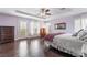 This spacious primary bedroom is bathed in natural light, has hardwood floors, and a tray ceiling at 872 Timber Walk Dr, Henderson, NV 89052