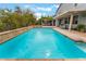 Beautiful swimming pool and landscaped backyard, with mature trees and a covered seating area at 872 Timber Walk Dr, Henderson, NV 89052