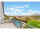 A Balcony view showcasing lush greenery, a pool, and homes under a bright sky at 872 Timber Walk Dr, Henderson, NV 89052