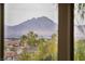 Stunning mountain views framed by lush palm trees seen from home's window at 872 Timber Walk Dr, Henderson, NV 89052