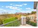 Balcony view of lush greenery, mountains, and neighborhood homes under a bright sky at 872 Timber Walk Dr, Henderson, NV 89052