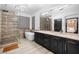 Modern bathroom featuring a glass-enclosed shower, soaking tub, double vanity with black cabinets, and decorative lighting at 9417 Churchill Downs Dr, Las Vegas, NV 89117