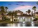 Charming two-story home featuring a three-car garage, tile roof, and beautifully landscaped front yard with mature trees at 9417 Churchill Downs Dr, Las Vegas, NV 89117