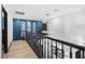 Upstairs hallway featuring modern lighting, dark railings, and decorative wall art at 9417 Churchill Downs Dr, Las Vegas, NV 89117