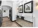 Elegant hallway featuring a mirrored cabinet, stylish decor, and dark-framed doorways at 9417 Churchill Downs Dr, Las Vegas, NV 89117