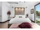 Comfortable main bedroom showcasing a luxurious bed, bedside tables with lamps, and a view of the outdoors at 9417 Churchill Downs Dr, Las Vegas, NV 89117
