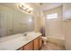 Bathroom showcasing a vanity, commode, and shower/tub combination at 104 Breezy Tree Ct # 201, Las Vegas, NV 89145