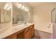 Bright bathroom featuring a large mirror, vanity, and a shower-tub combination at 104 Breezy Tree Ct # 201, Las Vegas, NV 89145