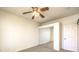 Spare bedroom with mirrored closet doors and a ceiling fan at 104 Breezy Tree Ct # 201, Las Vegas, NV 89145