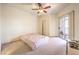 Spacious bedroom with a ceiling fan, and glass sliding doors to a patio at 104 Breezy Tree Ct # 201, Las Vegas, NV 89145