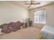 Bedroom featuring large window, ceiling fan, desk, and sleeping area at 104 Breezy Tree Ct # 201, Las Vegas, NV 89145