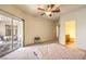 Large bedroom with ceiling fan and sliding glass door leading to a patio at 104 Breezy Tree Ct # 201, Las Vegas, NV 89145
