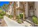 Beautiful home exterior with desert landscaping, a walkway, and a covered entrance at 104 Breezy Tree Ct # 201, Las Vegas, NV 89145