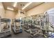 Well-equipped gym with treadmills, elliptical machines, weightlifting stations, and large mirrors at 104 Breezy Tree Ct # 201, Las Vegas, NV 89145