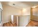 Hallway with hardwood floors, neutral paint, and a staircase with a half-wall at 104 Breezy Tree Ct # 201, Las Vegas, NV 89145