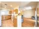 Kitchen and living room with tile and hardwood floors, granite countertops, and wood cabinets at 104 Breezy Tree Ct # 201, Las Vegas, NV 89145