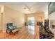 Cozy living room featuring hardwood floors, a ceiling fan, and a fireplace at 104 Breezy Tree Ct # 201, Las Vegas, NV 89145