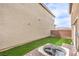 This backyard has artificial turf, a patio, and backs to a wall at 1115 Brilliant Meadow Ave, North Las Vegas, NV 89086