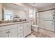 Bright bathroom features double sinks with modern fixtures and a glass-enclosed shower at 1115 Brilliant Meadow Ave, North Las Vegas, NV 89086