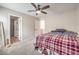 Bedroom with ceiling fan and open doorway to the ensuite bathroom at 1115 Brilliant Meadow Ave, North Las Vegas, NV 89086