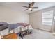 Bedroom featuring ceiling fan, carpet, and large window for natural light at 1115 Brilliant Meadow Ave, North Las Vegas, NV 89086