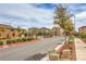 Gated community entrance with lush landscaping and well-maintained streets at 1115 Brilliant Meadow Ave, North Las Vegas, NV 89086