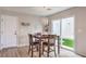 Bright dining area features a modern light fixture, table, and backyard access at 1115 Brilliant Meadow Ave, North Las Vegas, NV 89086