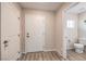 Bright entryway with wood floors, white walls, and access to a half bath at 1115 Brilliant Meadow Ave, North Las Vegas, NV 89086