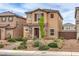 Two-story home featuring desert landscaping, a brick pathway, and neutral color scheme at 1115 Brilliant Meadow Ave, North Las Vegas, NV 89086