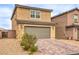 Beautiful two-story home with a two-car garage, desert landscaping and a paver driveway at 1115 Brilliant Meadow Ave, North Las Vegas, NV 89086