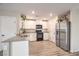 Well-lit kitchen featuring stainless steel refrigerator, and sleek countertops at 1115 Brilliant Meadow Ave, North Las Vegas, NV 89086