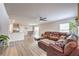 Open concept living room with wood floors and a large, comfortable sectional at 1115 Brilliant Meadow Ave, North Las Vegas, NV 89086