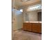 Bathroom with a glass-enclosed shower, double sink vanity, and modern lighting fixtures at 1654 Danbury Crossing Dr, Henderson, NV 89052