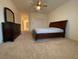 Spacious bedroom with a neutral carpet, a ceiling fan, and a dark dresser with a mirror at 1654 Danbury Crossing Dr, Henderson, NV 89052