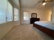Carpeted bedroom showcasing a ceiling fan, carpeted floor, and natural light from the window at 1654 Danbury Crossing Dr, Henderson, NV 89052