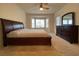 Spacious bedroom features a ceiling fan, bay window, and dresser with a decorative mirror at 1654 Danbury Crossing Dr, Henderson, NV 89052