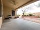 Covered patio showcasing a ceiling fan, seating area, brick trim, and view of the landscaped backyard at 1654 Danbury Crossing Dr, Henderson, NV 89052