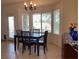 Bright dining area features tile flooring, a dining table with seating, and natural light from large windows at 1654 Danbury Crossing Dr, Henderson, NV 89052