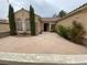 Inviting front entrance with well-maintained landscaping and a spacious courtyard area for outdoor enjoyment at 1654 Danbury Crossing Dr, Henderson, NV 89052
