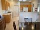 Kitchen featuring tile flooring, bright wooden cabinets, white appliances, and a breakfast bar at 1654 Danbury Crossing Dr, Henderson, NV 89052