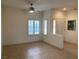 Bright living area with tile flooring, large windows, and access to other parts of the house at 1654 Danbury Crossing Dr, Henderson, NV 89052