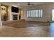 Open living room featuring tiled floors, a fireplace, and a ceiling fan for added comfort at 1654 Danbury Crossing Dr, Henderson, NV 89052