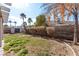 Lush backyard with trees, block wall, and partial shed creates a serene outdoor space at 178 Beach Oak Ave, Henderson, NV 89002