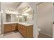 Bathroom featuring dual sinks, granite countertops, and wood cabinetry at 178 Beach Oak Ave, Henderson, NV 89002