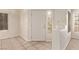 Bright entryway with tile flooring, a security door, and natural light from the window at 178 Beach Oak Ave, Henderson, NV 89002