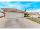 Spacious two-car garage with a wide driveway and desert landscaping in front of the property at 178 Beach Oak Ave, Henderson, NV 89002