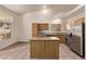 Bright and airy kitchen with stainless steel appliances, granite countertops, and a center island perfect for food preparation at 178 Beach Oak Ave, Henderson, NV 89002